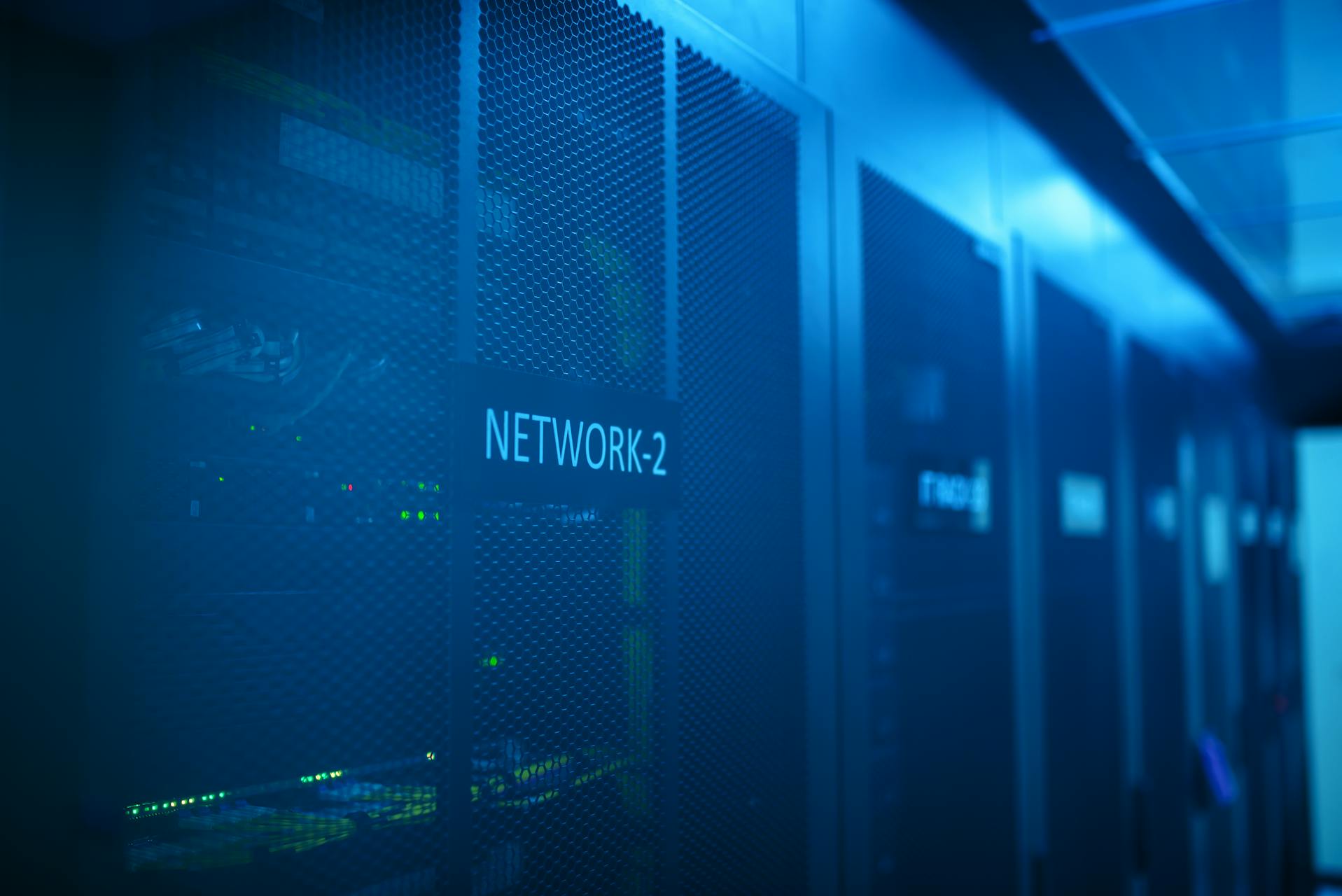 Server rack in a blue-lit data centre corridor — infrastructure defined in code, not accumulated by hand